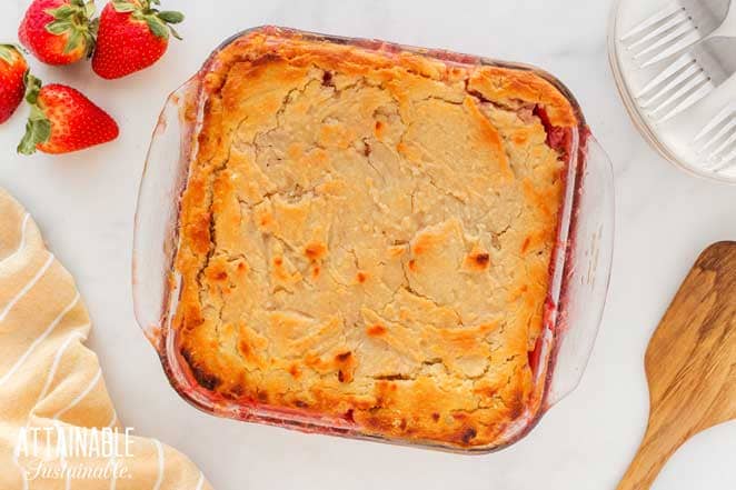 strawberry cobbler in a square pan from above, showing nicely browned crust