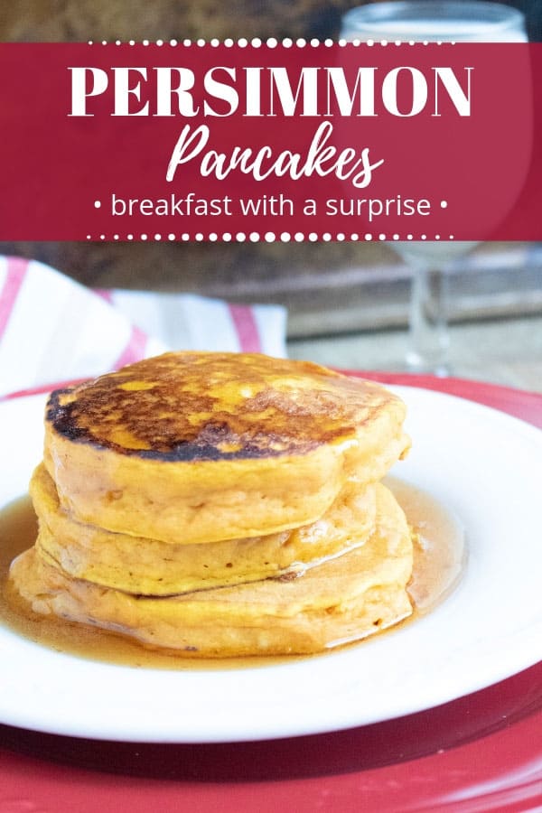 persimmon pancakes on a white dish with a red charger and a glass of milk