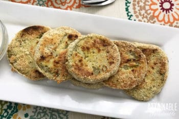 easy fried green tomato recipe finished and served on a white rectangular plate