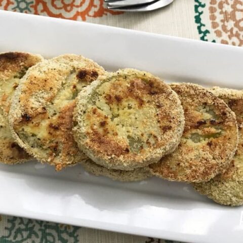 easy fried green tomato recipe finished and served on a white rectangular plate