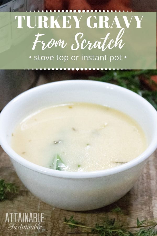 turkey gravy in a white bowl with herbs