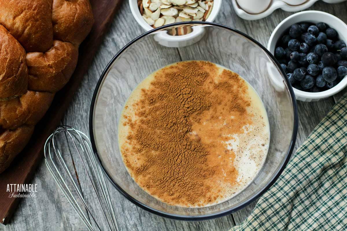 Ingredients for french toast casserole, milk and eggs in a glass bowl.