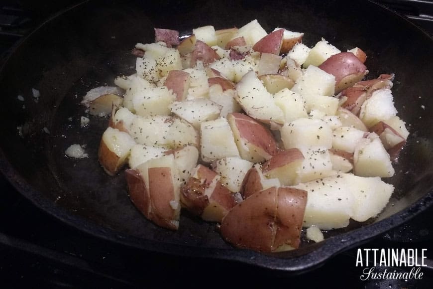 cubed red potatoes in a cast iron pan