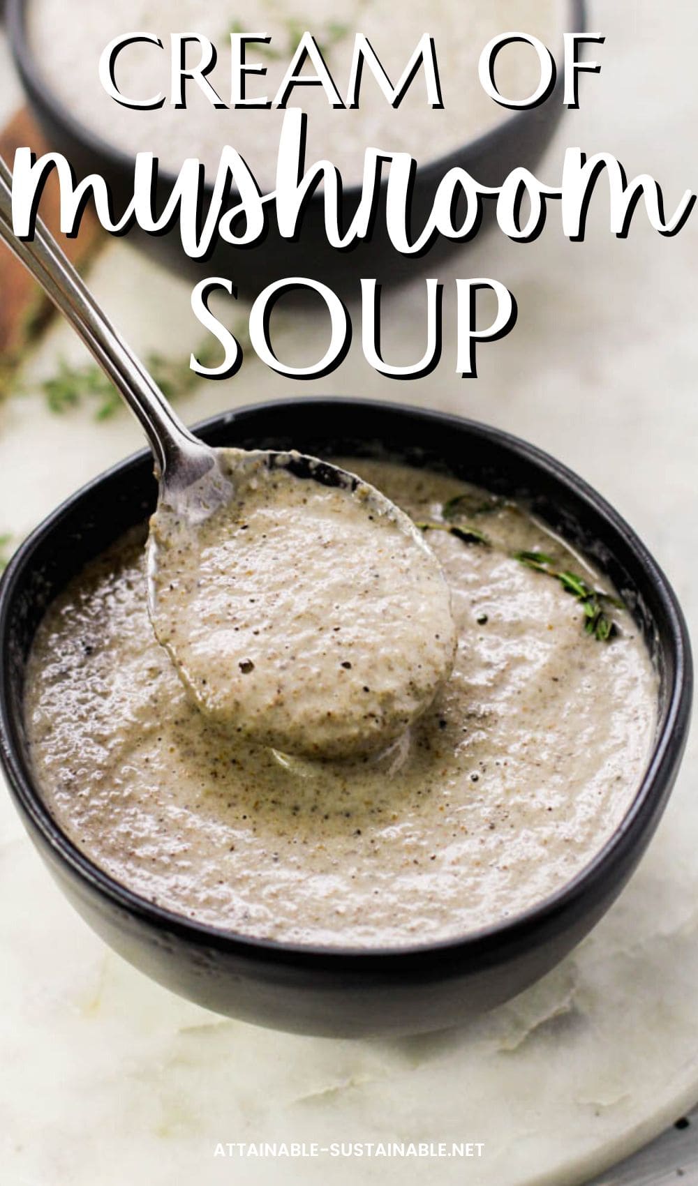 brown bowl full of cream of mushroom soup, with a spoonful hovering over the bowl.