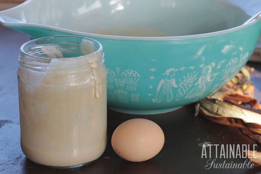 sourdough starter, egg, in front of blue pyrex bowl
