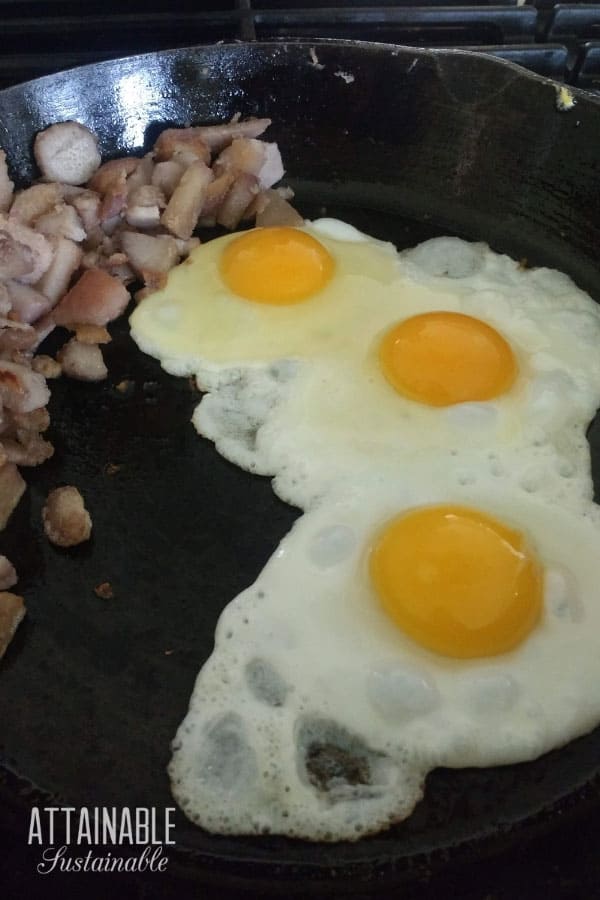 3 fried eggs in a cast iron pan