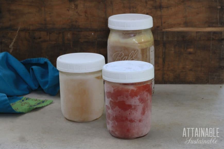 3 glass jars with frost on the outside and white plastic lids