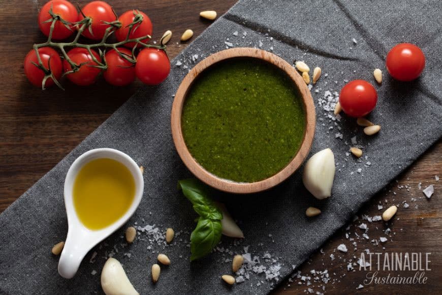 food ingredients from above: oil, cherry tomatoes, a bowl of green sauce