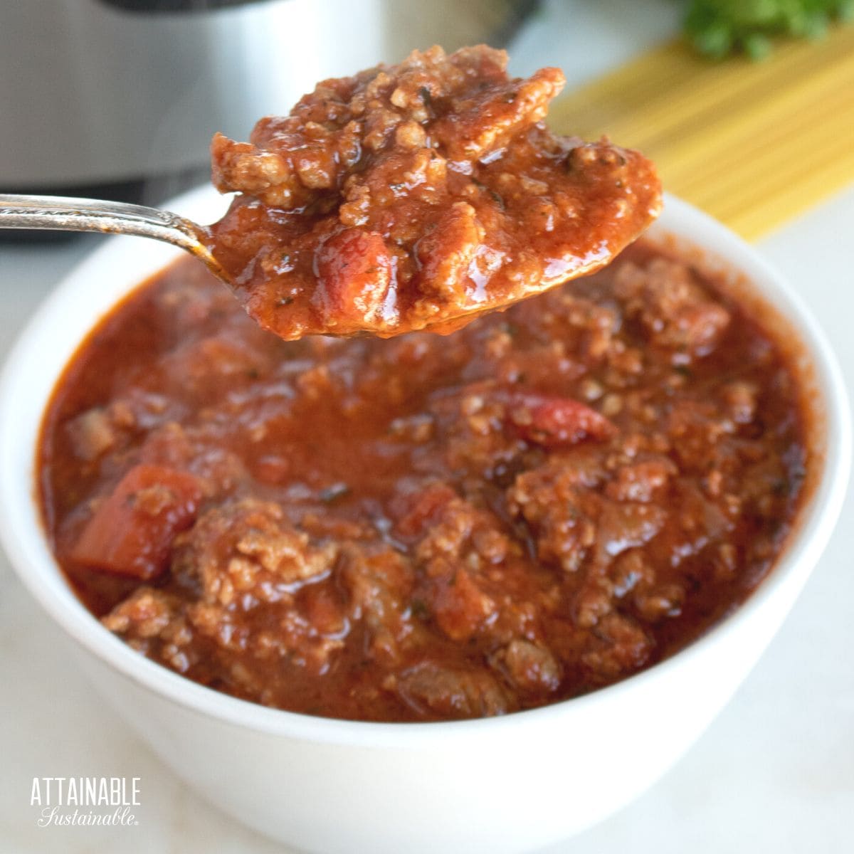 red meat sauce on a spoon.