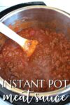 red meat sauce in an instant pot with a wooden spoon.