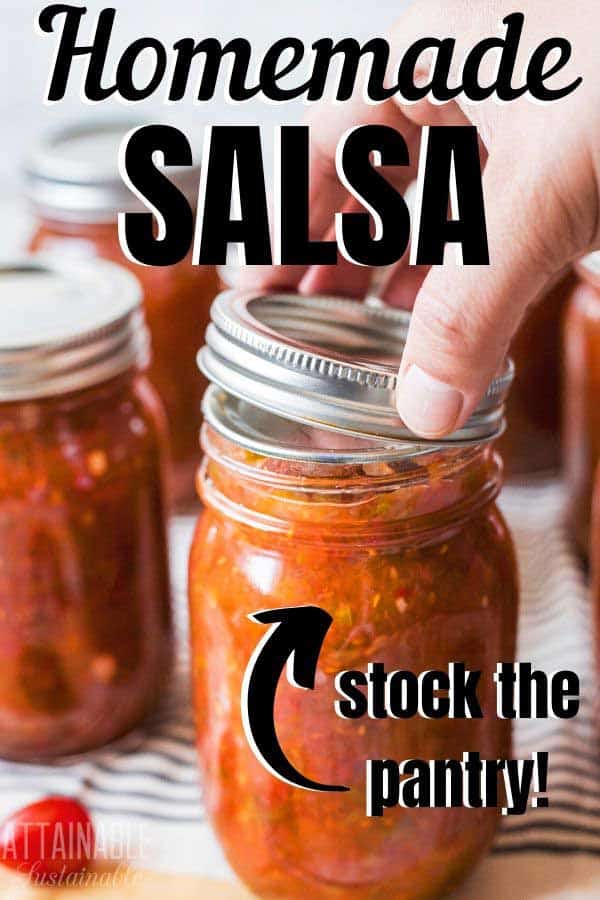 jar of salsa, with hand putting lid in place