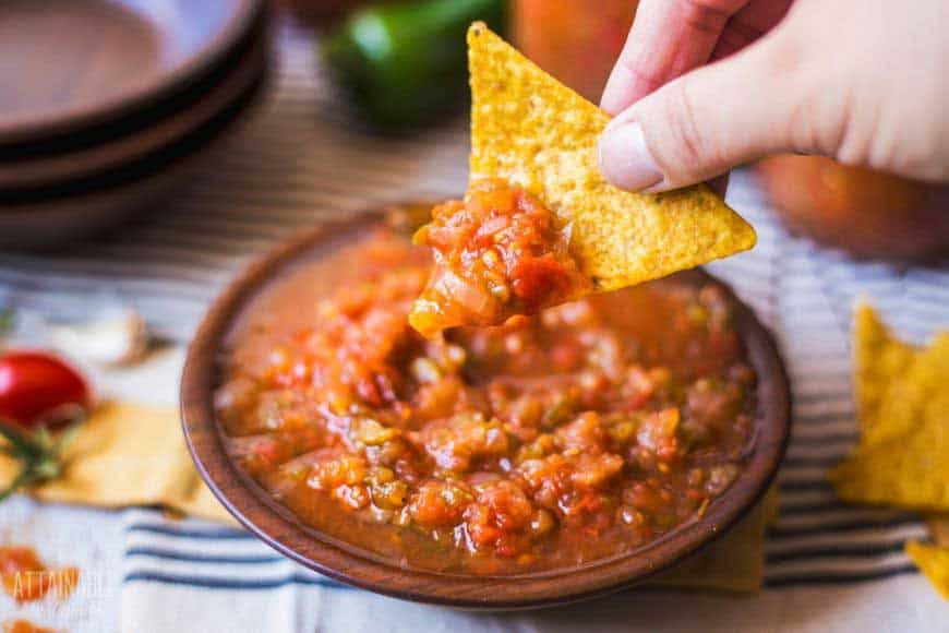 bowl full of salsa with yellow chip