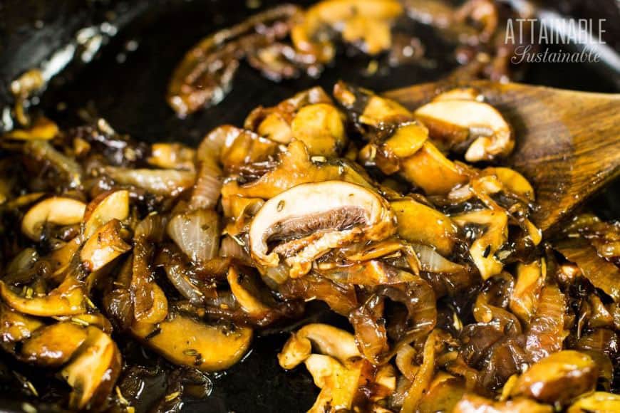 mushrooms and onions on a wooden spoon