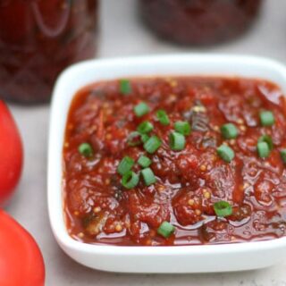 tomato chutney in jars and some in a square white dish