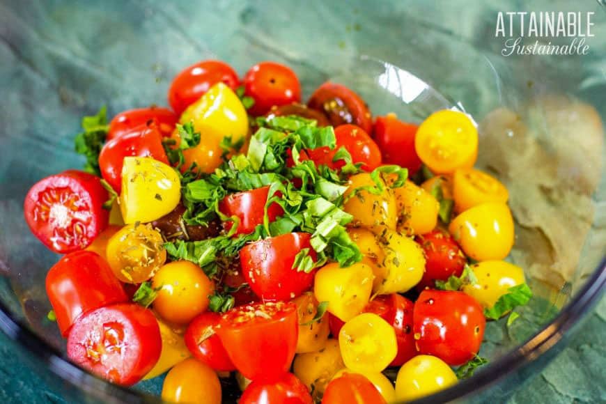 yellow and red cherry tomatoes in a clear bowl
