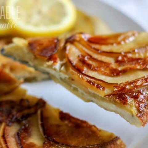 apple tansey in a white dish, one slice being served