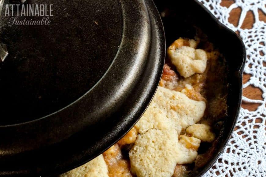 old fashioned peach cobbler in cast iron dutch oven