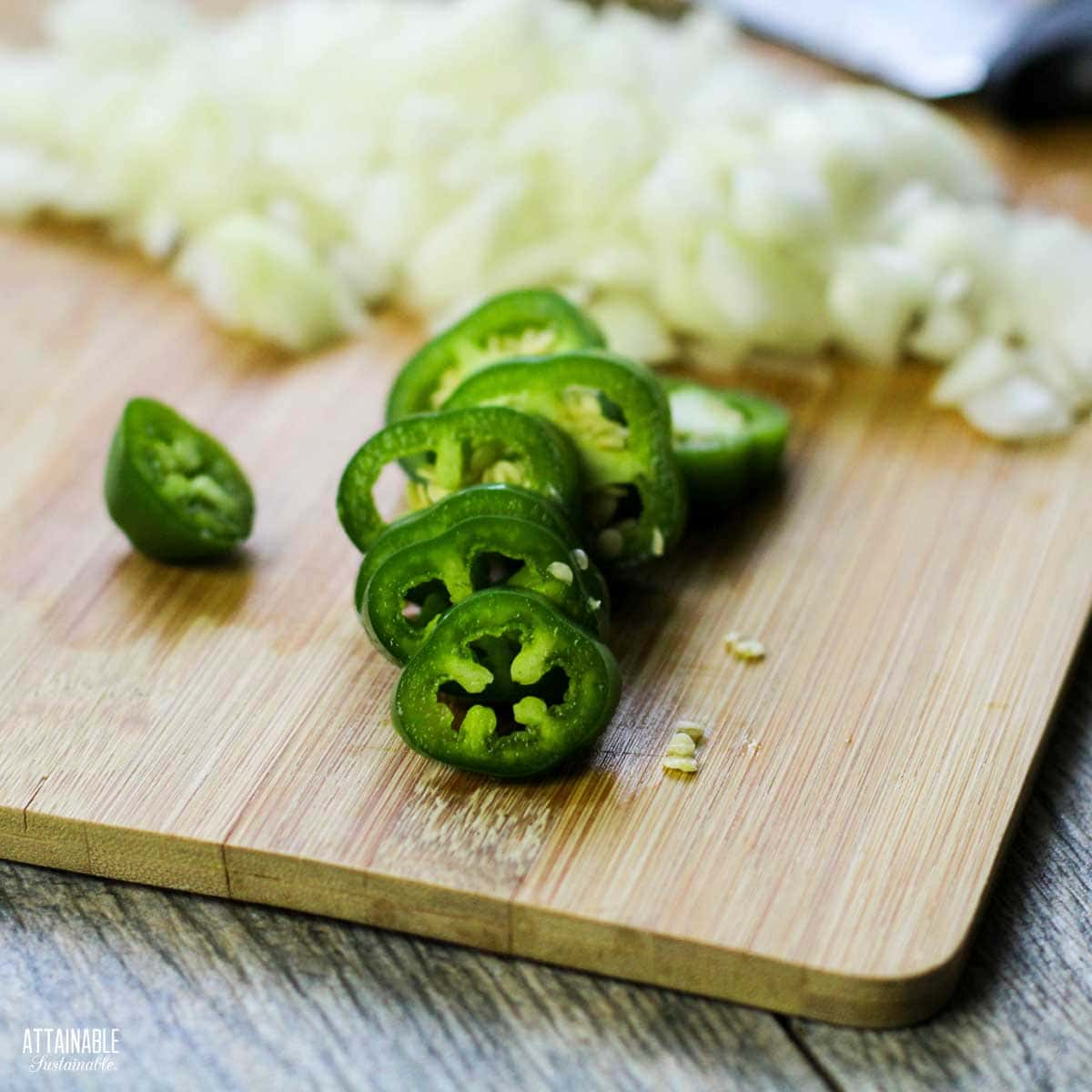 chopped onion and jalapeno on a cutting board.