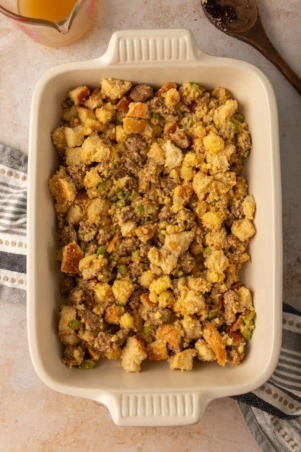 uncooked sausage dressing in a casserole dish