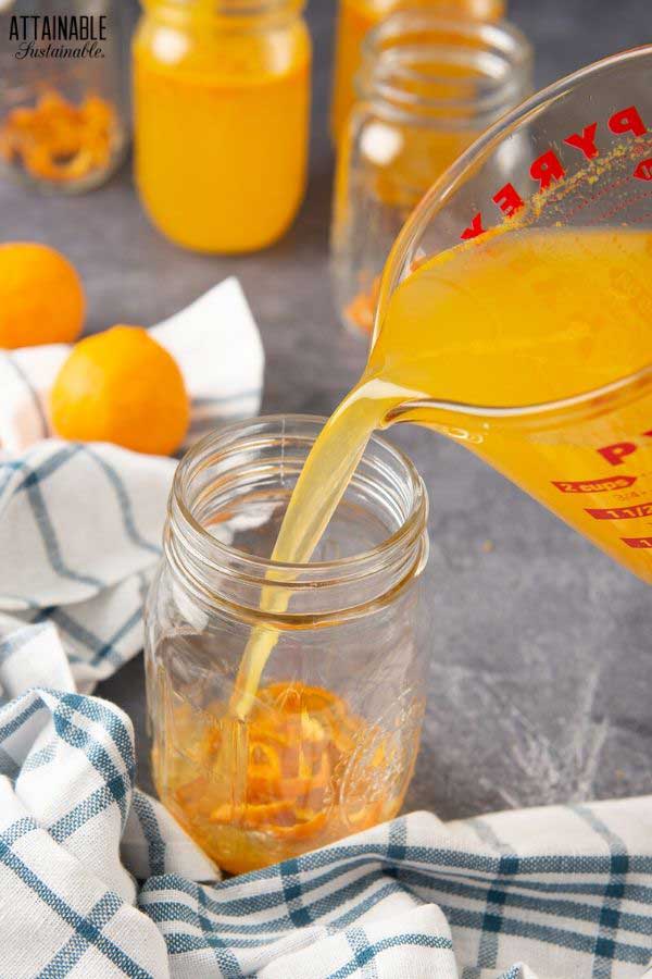 pouring juice into a glass jar