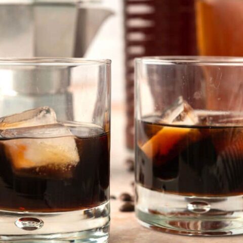 two highball glasses with kahlua and ice