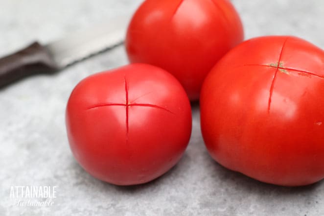 3 red ripe tomatoes with a thin X slashed in them