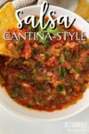 close up of salsa recipe in a bowl, tortilla chip scooping some out.