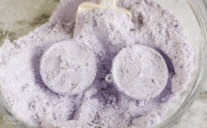 2 half rounds in a bowl of purple powder to form bath fizzies