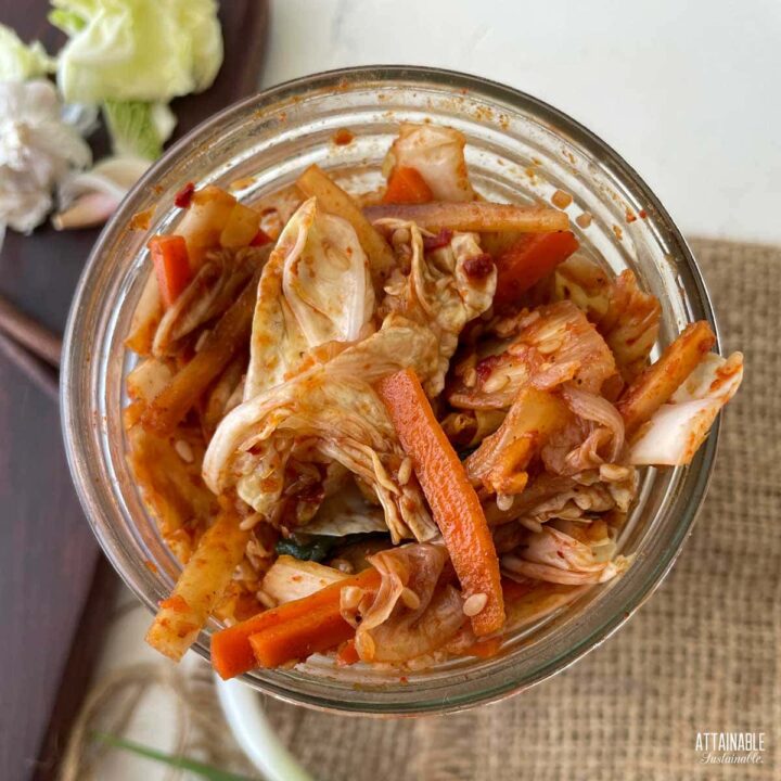 fresh veggies coated with red seasonings in a glass jar from above.