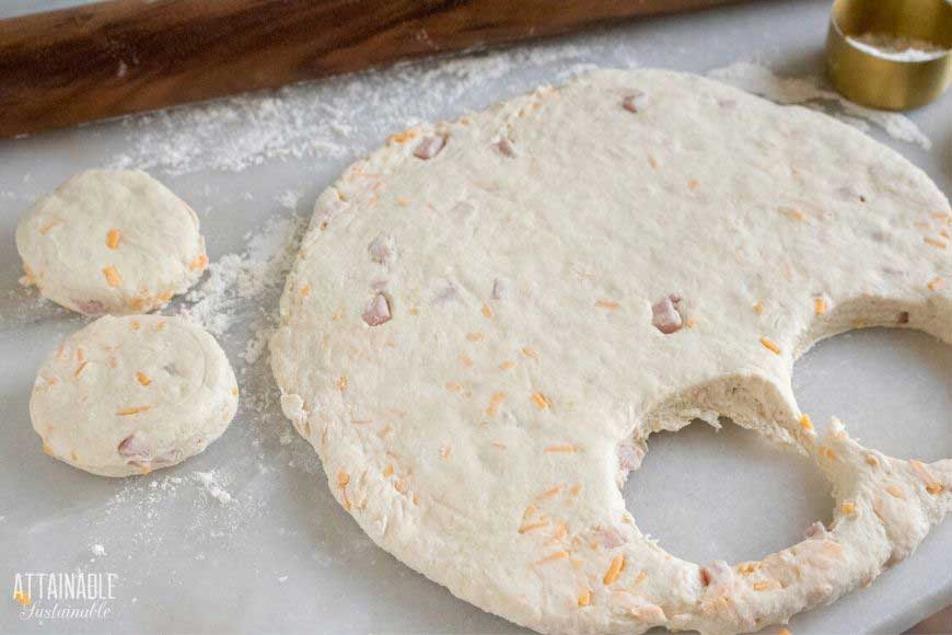 biscuit dough rolled on a white surface