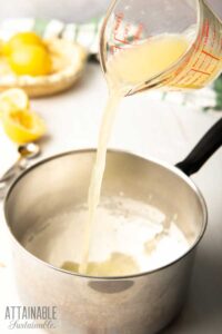 pouring lemon juice into a pot