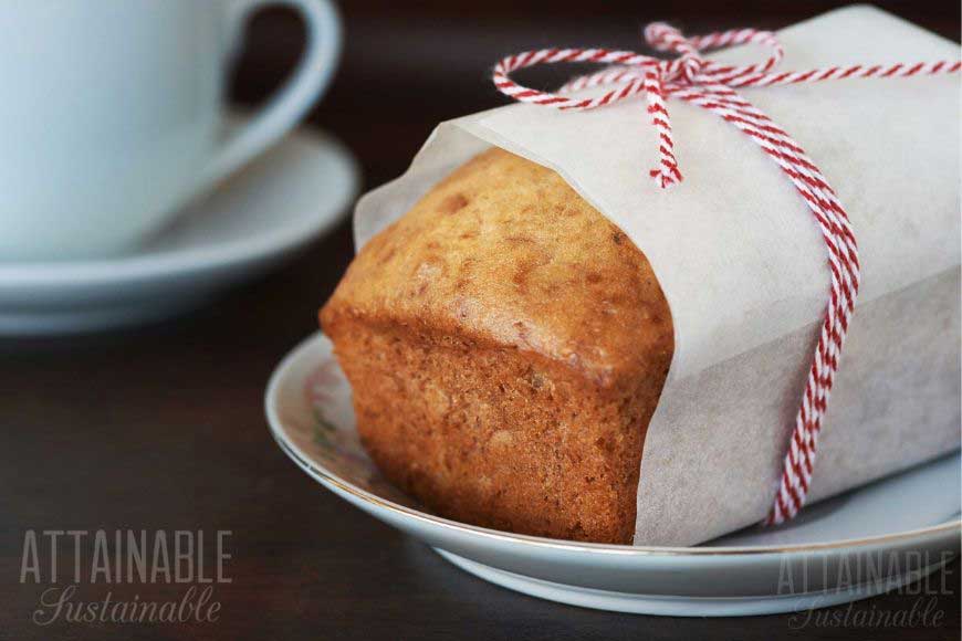 loaf of bread wrapped in white paper and tied with red ribbon as a food gift