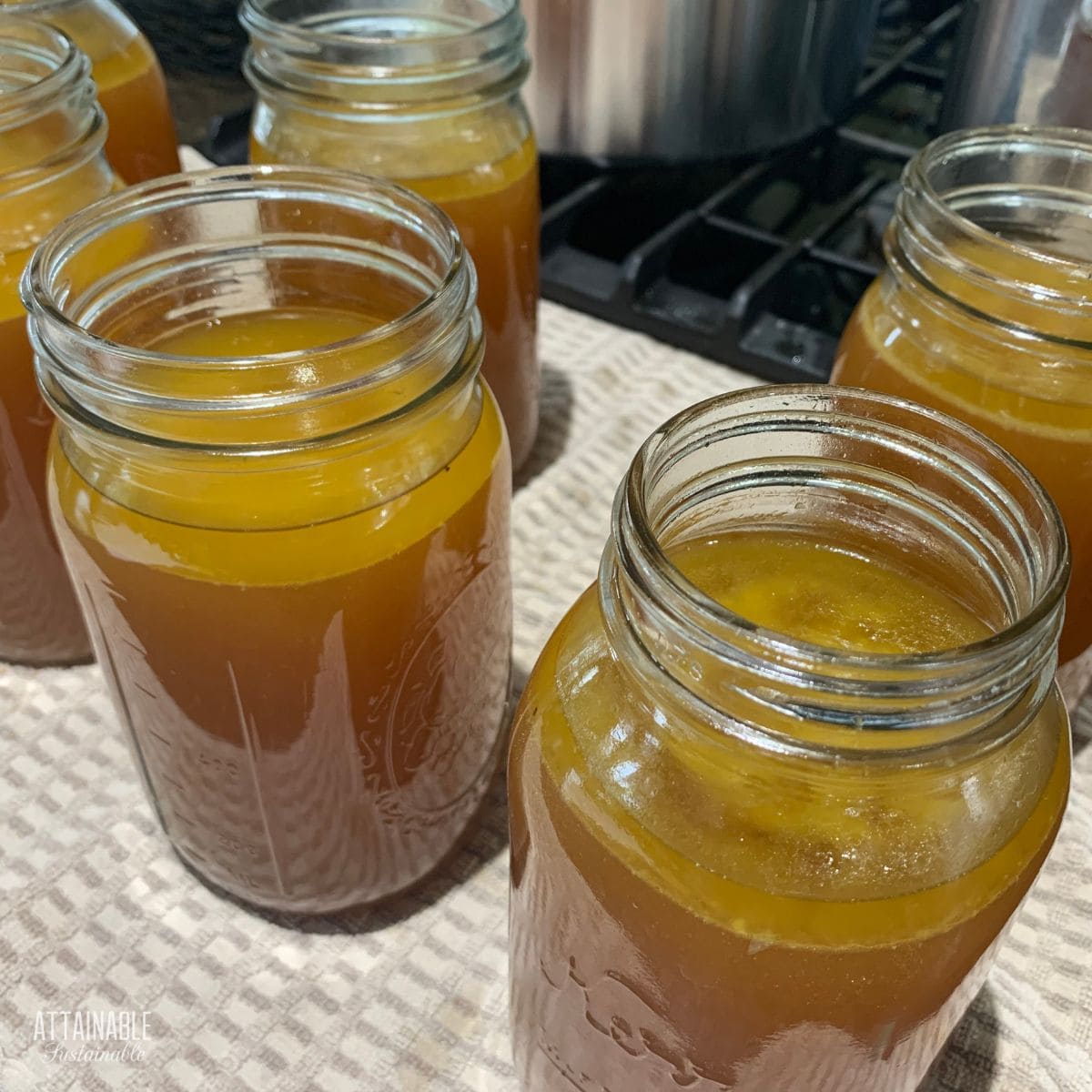 dark brown chicken broth, in jars ready for canning