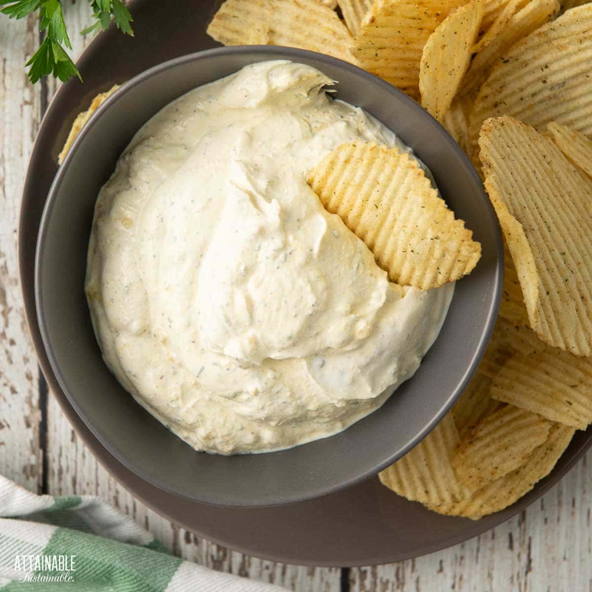 french onion dip in a brown bowl from above, with chips.