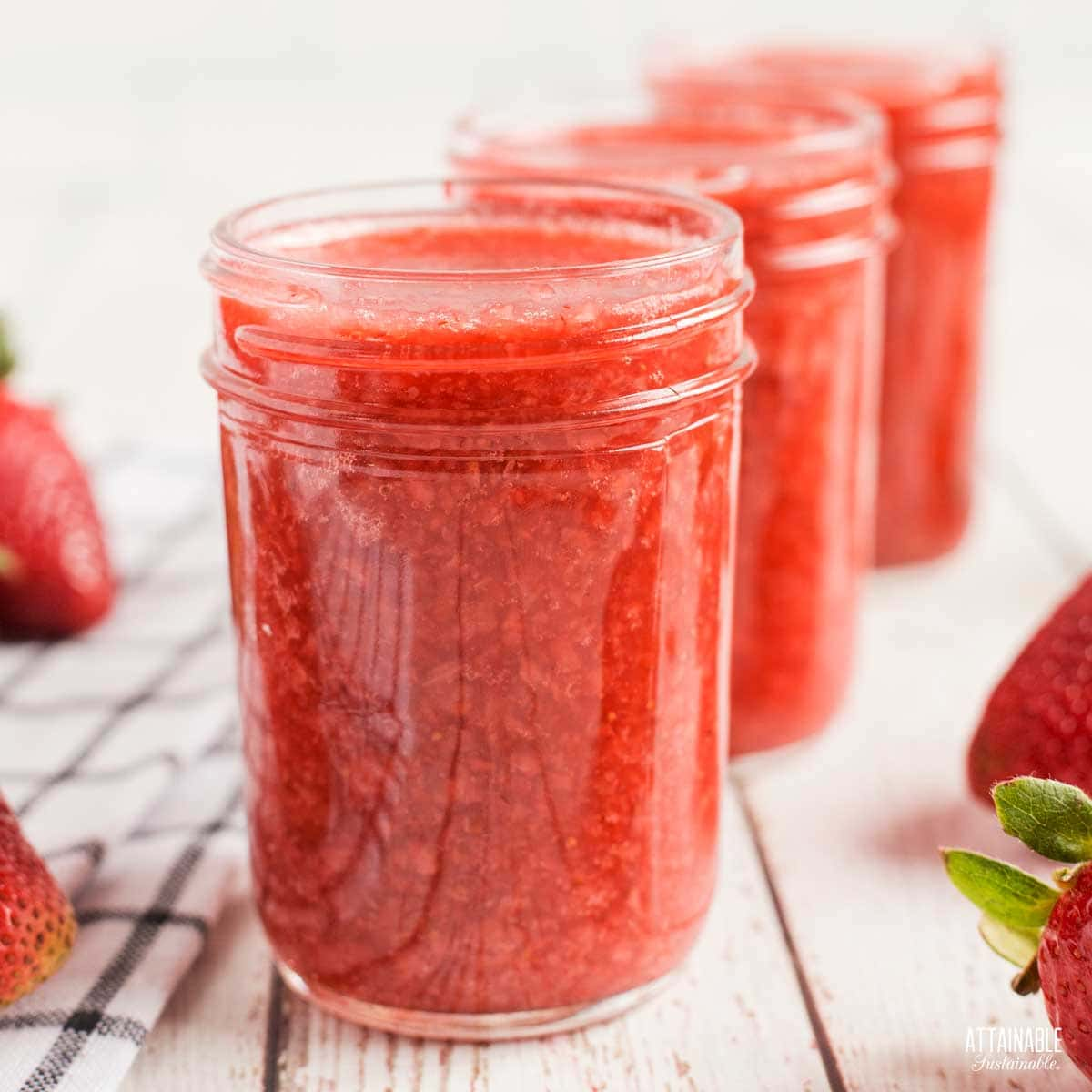 3 jars of strawberry jam ready for lids.