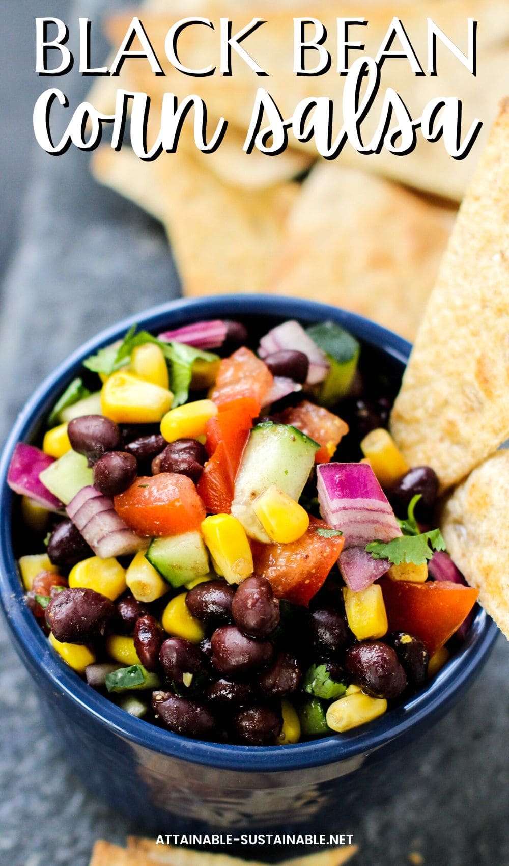 black bean dip with whole beans, corn, and veggies in a blue bowl.