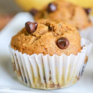 close up of pumpkin banana muffin in a white cupcake liner.