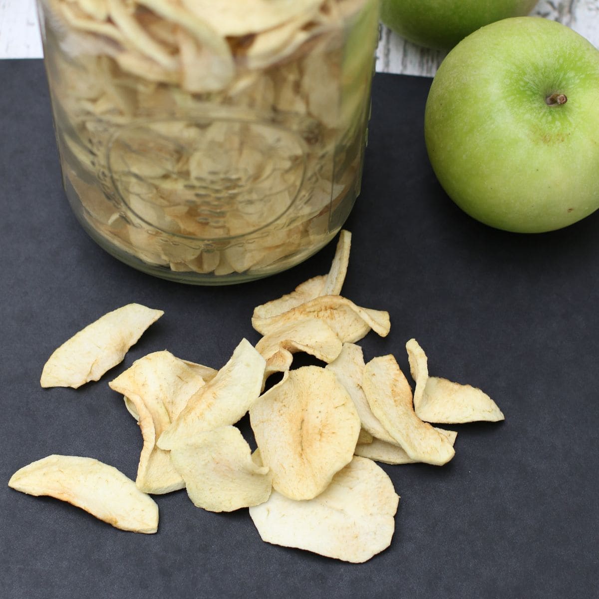 dried apple slices on a black background.