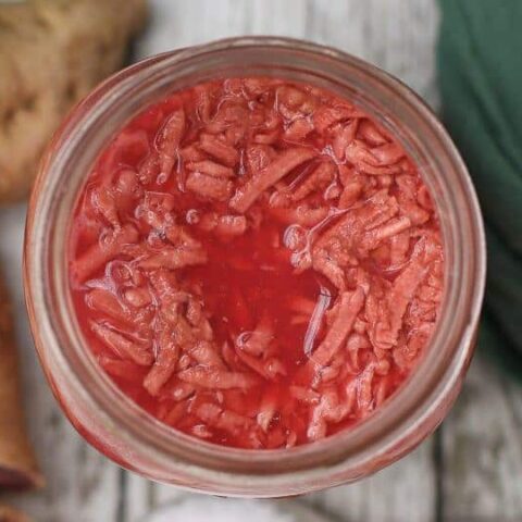 glass jar from above filled with shredded fermented purple sweet potatoes