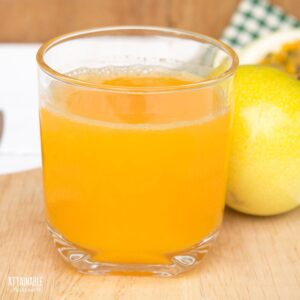 glass full of orange colored passion fruit juice.