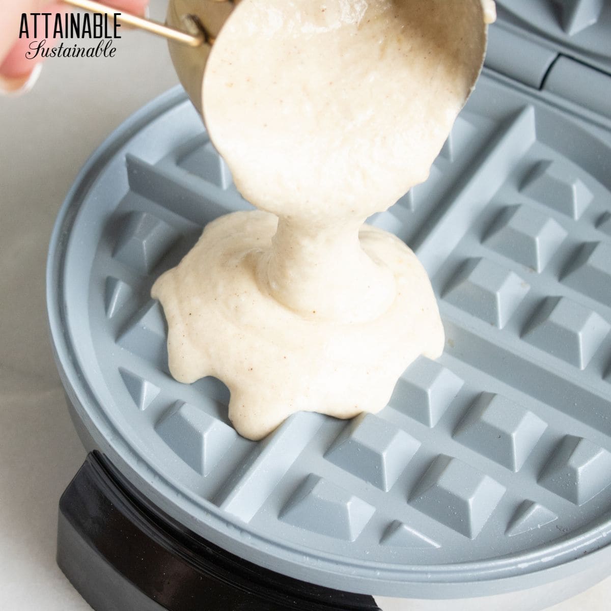 waffle batter being poured into a waffle iron.