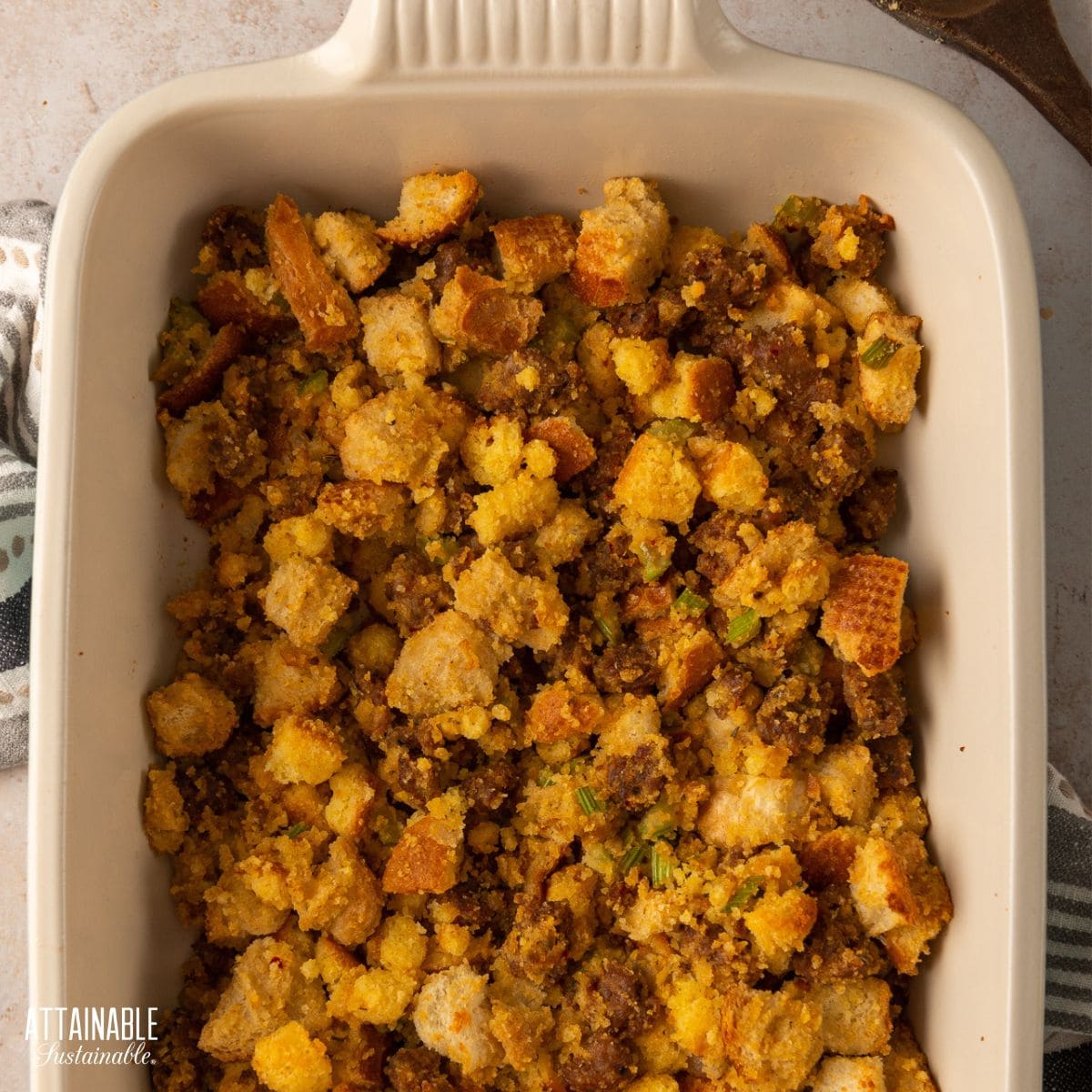 cooked cornbread stuffing in a white casserole dish.