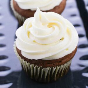 pumpkin cupcakes on a blue tray.