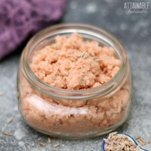SHALLOW glass jar filled with pink salt scrub.