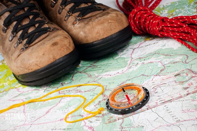 boots on a map with a compass and red rope