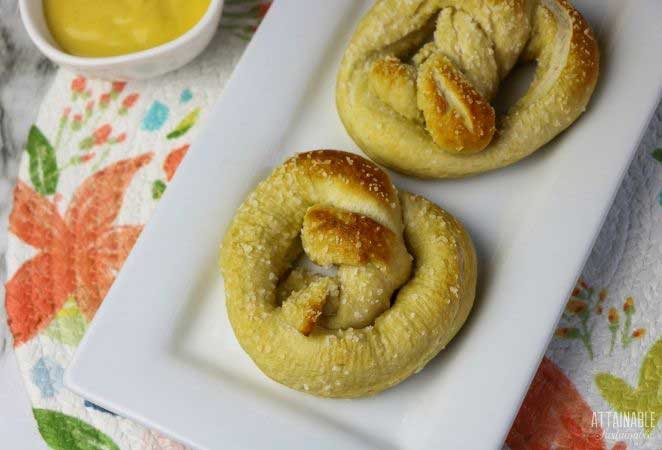 homemade soft pretzels on a rectangular white plate