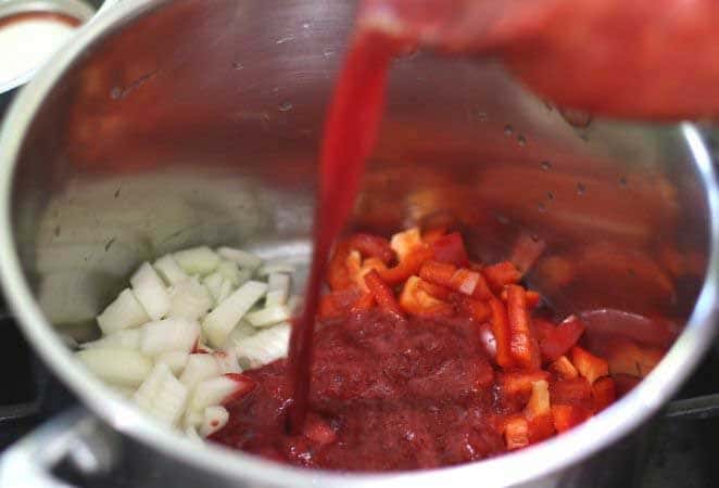 onions and red pepper in a pot