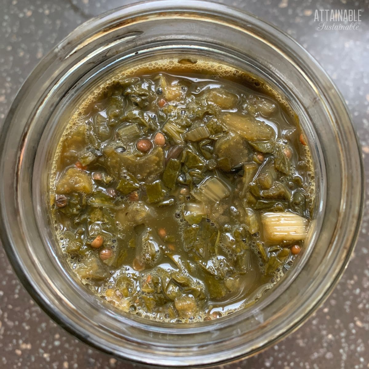 beet green kraut in a glass jar from above.