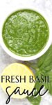 fresh green basil sauce in a white bowl with lemon and basil leaves