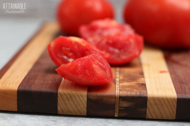 wedges of fresh tomato on a cutting board